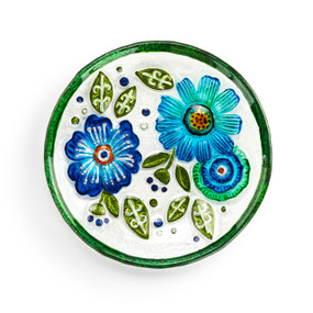 A mini round glass plate with blue flowers and a green rim.