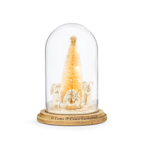 A light up cloche with a wood base and a nativity scene with a gold bottle brush tree inside. The base has the saying "O Come O Come Emmanuel".