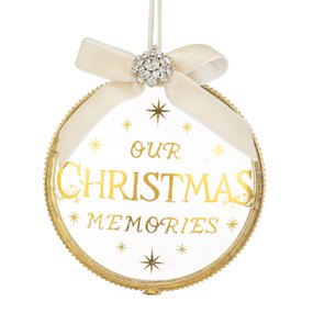 A clear glass locket frame ornament with "Our Christmas Memories" on the outside.