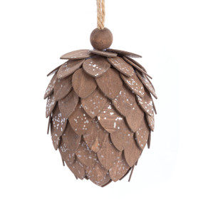 A small pinecone shaped ornament made with brown woodchips and dusted with silver sparkle.
