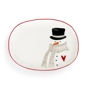 A white oval ceramic platter with a red rim and a snowman wearing a scarf on one side.