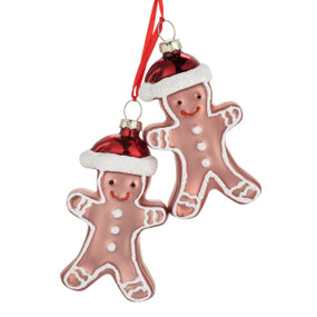 Two brown blown glass ornaments shaped like gingerbread men wearing red santa hats.