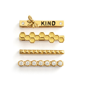 Four different gold charms that fit on a smart watch band. One has the word "kind" and a bee.