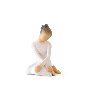 Front view: seated figure in cream dress with crossed arms