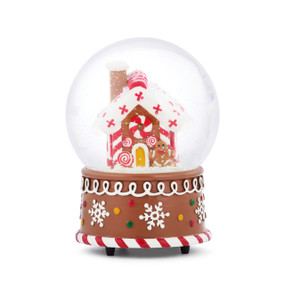 A musical snow globe with a brown base with snowflake decoration and the round top has a snowy gingerbread house inside.