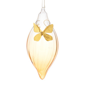 A teardrop shaped light amber milk glass ornament with a gold butterfly on the front.