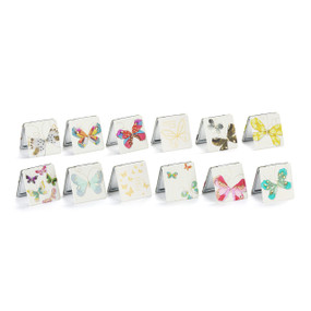 A set of 12 square white pocket mirrors with different butterflies on the front displayed slightly open.
