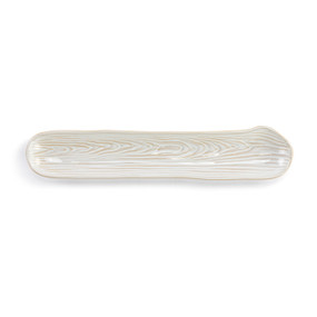 A cream ceramic long narrow cracker tray with a wood grain appearance.