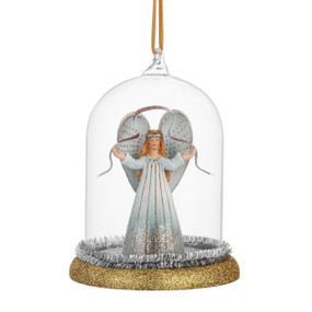 A glass cloche ornament with a glittery gold base. There is an angel inside holding a banner with the words "Peace & Love".