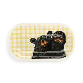 A rectangular melamine platter with a yellow and white plaid background and the image of a black bear waving its paw.