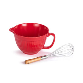 A red mixing bowl with a handle and spout. It comes with a wood handled whisk.