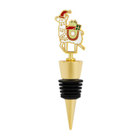 A gold and black bottle stopper with a white llama carrying Christmas presents on top.