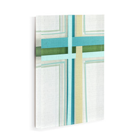 A white acrylic wall art tile with an illustrated modern cross in shades of blue and green displayed angled to the right.