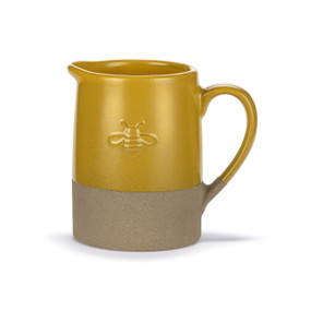 A mini dark yellow ceramic pitcher with a bee image on the front and a tan textured base.