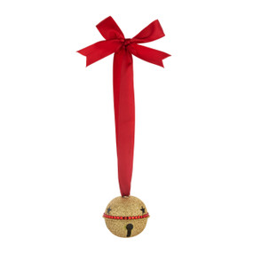 A gold sparkly jingle bell hanging from a large red ribbon.