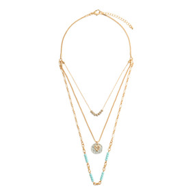 An adjustable gold chain necklace with three layers including turquoise and gold beads and a round silver charm with a gold heart.