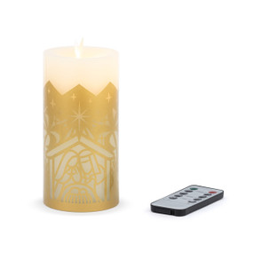 A flameless gold and cream pillar candle with an image of the nativity displayed next to a remote.