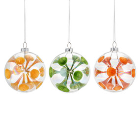 Three clear glass round ornaments with cones of a different color in each. The colors are yellow, green and orange.