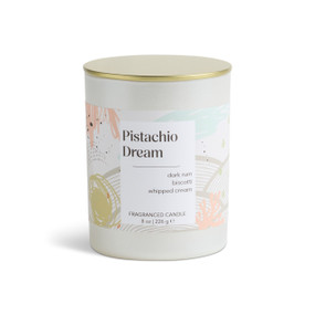 An 8 oz pistachio dream scented candle in a round white container with a gold lid.