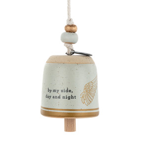 A small cream and gold bell with an angel wing and the saying "by my side, day and night".