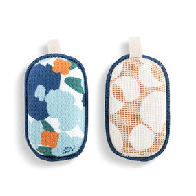 A set of two absorbent sponges in a blue and orange abstract pattern. Each has a fabric tab at the top for hanging.