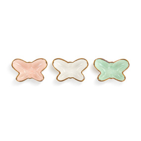 Three butterfly shaped mini ceramic dishes. The colors are pink, white and green and each has a gold rim.