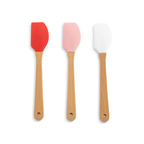 A set of three mini spatulas with wood handles and red, pink and white tops.