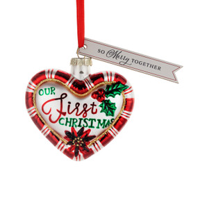 A heart shaped ornament with the saying "Our First Christmas" and a tag that says "So Merry Together".