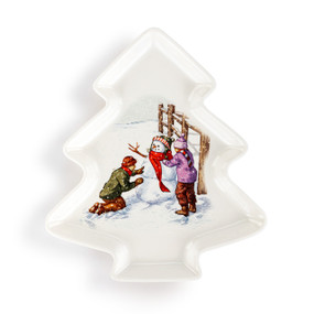 A tree shaped white ceramic dish with an illustration of two kids making a snowman in the center.