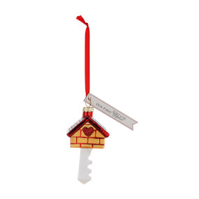 A house shaped key ornament with a tag that says "Our First Home".