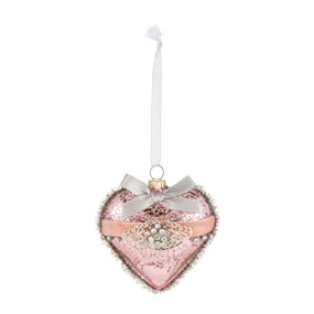 A pink heart shaped glass ornament decorated with beads, ribbon and tinsel.