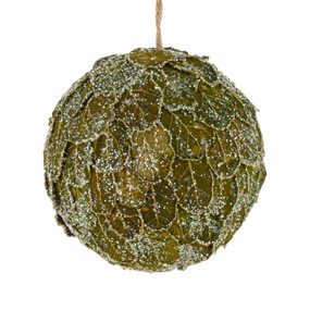 A round ornament decorated with green layered leaves and tiny beads.