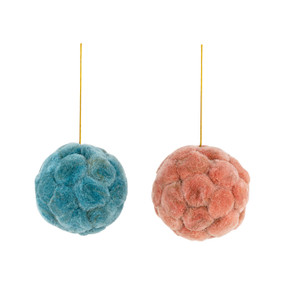 Two round ornaments made with small pom poms. One is pink and the other is blue.