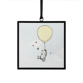 A small square sun catcher with a classic illustration of Pooh floating from a balloon.