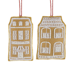 Two different brown fabric ornaments shaped like houses and decorated with white beads.