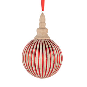 A wood carved ornament in a round ribbed shape. The outer edges are painted red.