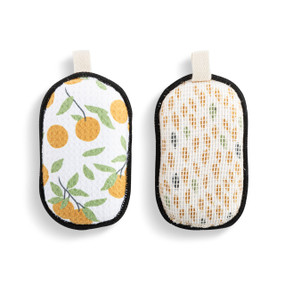 A set of two absorbent sponges with a white and orange citrus pattern. Each has a fabric tab at the top for hanging.