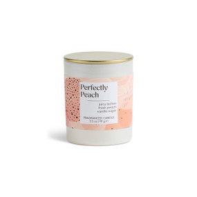 A 3.5 oz perfectly peach scented candle in a round white container with a gold lid.
