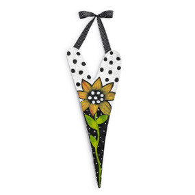 A metal door hanger in the shape of a tall heart. The heart is black and white with a sunflower and hangs from a black polka dot ribbon.