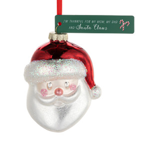 A blown glass ornament of Santa's face with a green tag that says "I'm Thankful for my Mom, my Dad and Santa Claus".