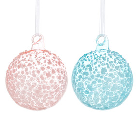 Two round milk glass ornaments one in light pink and the other in light blue.