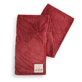 A red and white striped blanket with a fabric patch in the corner of Winnie the Pooh and friends. The patch has the saying "Christmas is better when you share it together".