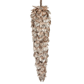 An ornament shaped like a long thin pinecone with the edges coated in sparkly gold.