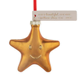 A blown glass ornament of a gold smiling star. There is a cream tag with the saying "You're so beautiful, you're worth a million stars to me".