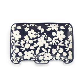 A rectangular navy ceramic double spoon rest with illustrated white flowers.