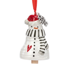 A small white bell shaped like a snowman wearing a green and white stiped scarf and has a silver metal snowflake charm at the top.