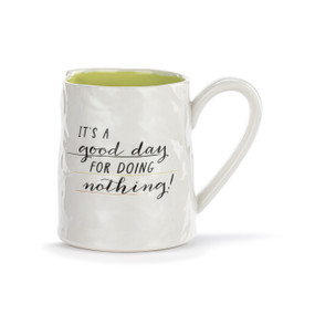 A white ceramic mug with a crinkly appearance. The interior is light green and the saying "It's a good day for doing nothing" is on the front.