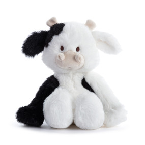 A small plush black and white cow displayed sitting.