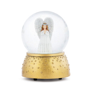 A musical snow globe with a gold base and a white angel inside holding her hands in prayer.