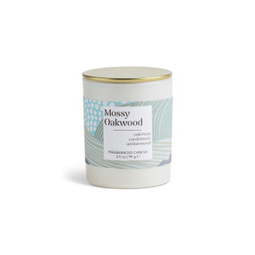 A 3.5 oz mossy oakwood scented candle in a round white container with a gold lid.